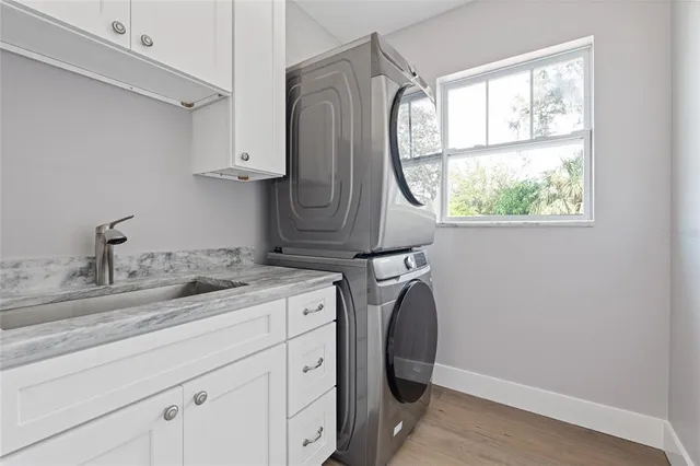 a utility room with cabinets washer and dryer