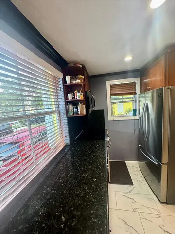 a kitchen view with a refrigerator and microwave