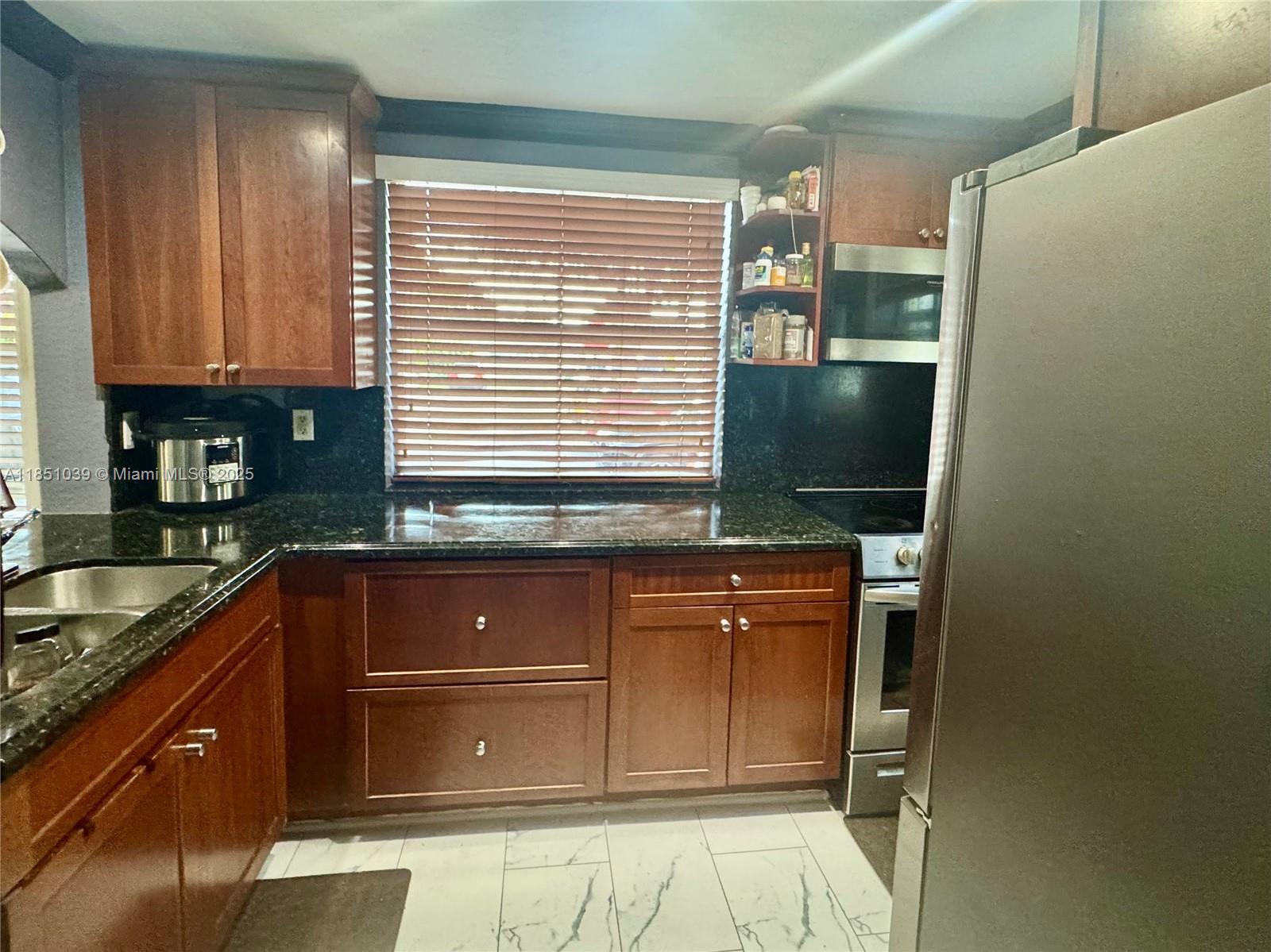 19550 Southwest 103rd Court, Unit 5 Cutler Bay, FL 33157 - Photo 14 of 28 a kitchen with a sink and cabinets