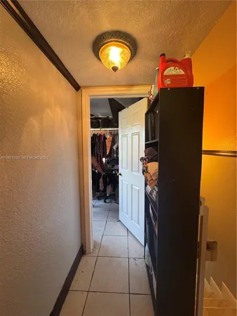 a hallway with a view of living room
