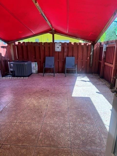 19550 Southwest 103rd Court, Unit 5 Cutler Bay, FL 33157 - Photo 20 of 28 a view of a backyard with table and chairs under an umbrella