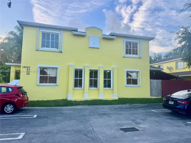 a view of a car parked in front of a building