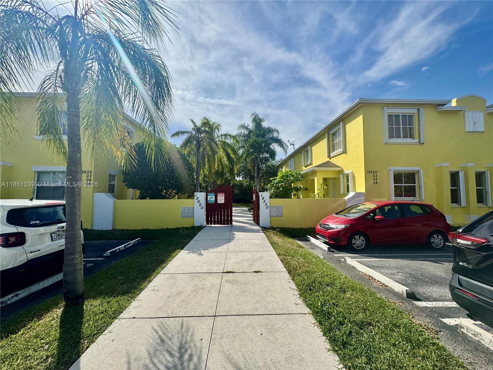 19550 Southwest 103rd Court, Unit 5 Cutler Bay, FL 33157 - Photo 4 of 28 a front view of a house with a garden
