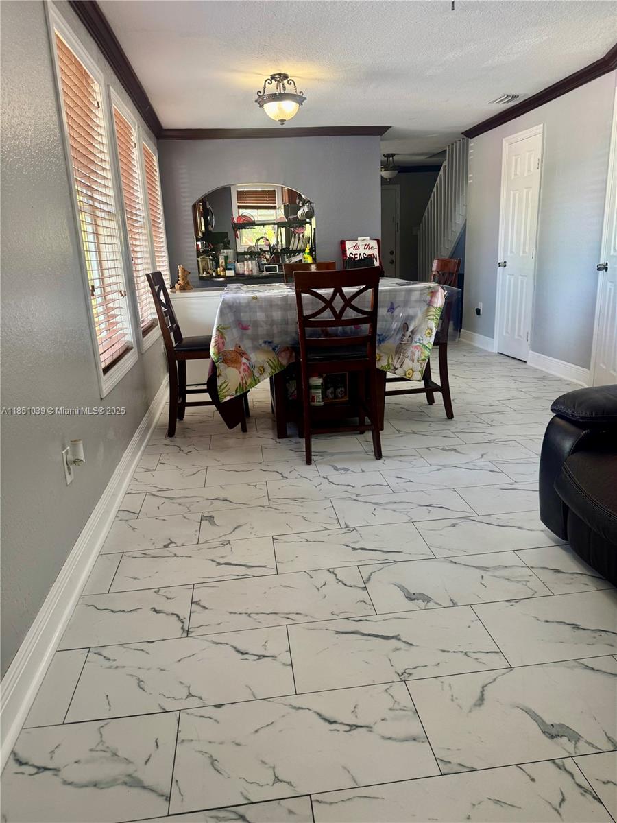19550 Southwest 103rd Court, Unit 5 Cutler Bay, FL 33157 - Photo 6 of 28 a living room with furniture and a large window