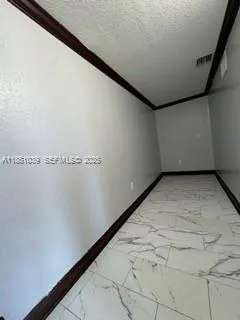 a kitchen view with a refrigerator and microwave