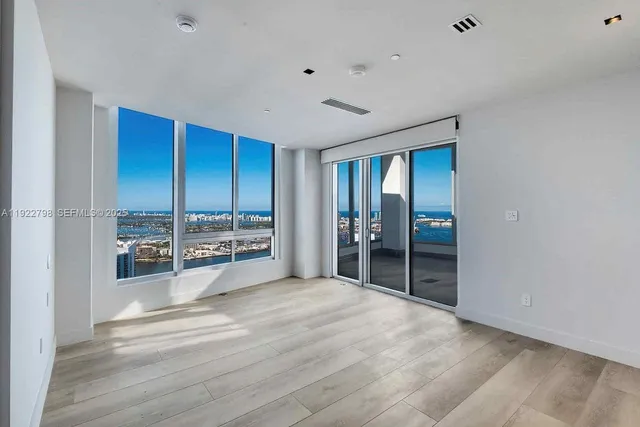 a large bedroom with a large bed and a large window