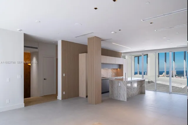 a view of a kitchen with furniture and wooden floor