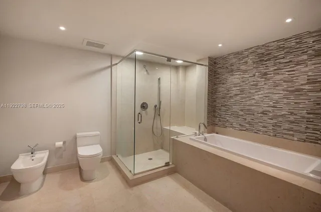 a bathroom with a toilet a sink and shower
