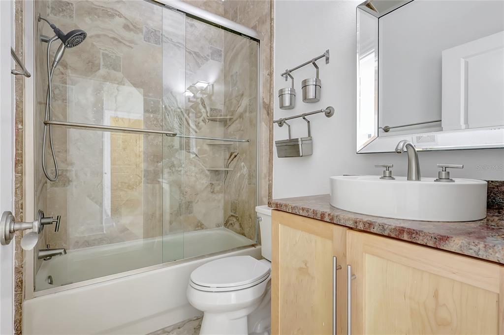 2863 Duncan Tree Circle Valrico, FL 33594 - Photo 20 of 53 a bathroom with a granite countertop sink mirror toilet and bathtub