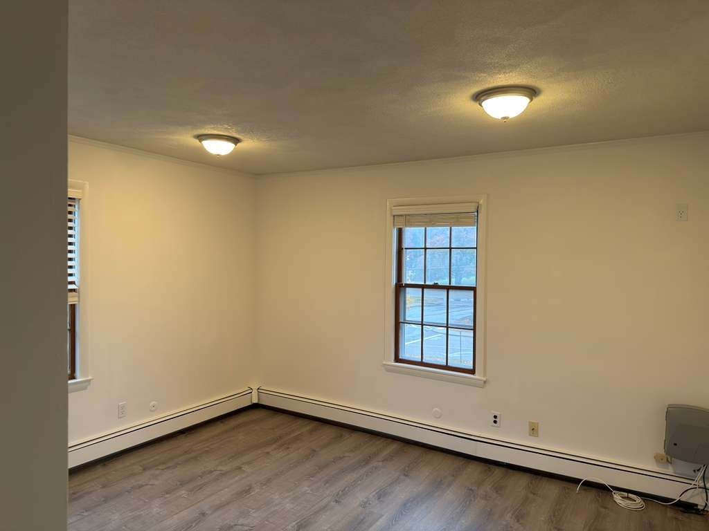 37 Exchange Street, Unit 37 Millis, MA 02054 - Photo 2 of 15 an empty room with a window