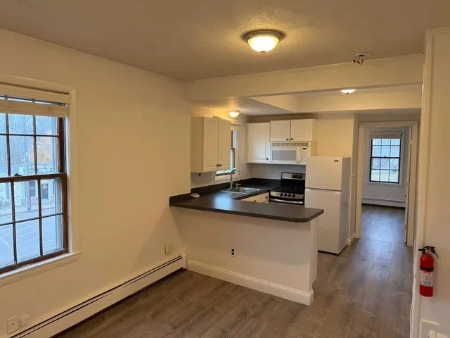 a kitchen with granite countertop a sink and a stove top oven