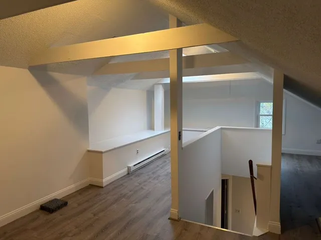 an empty room with wooden floor