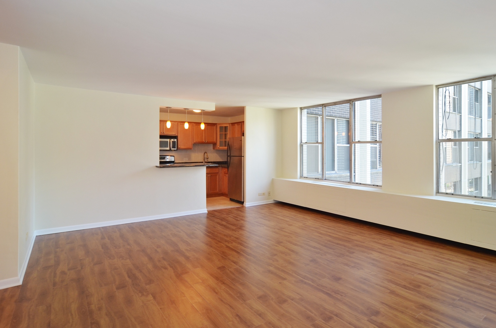 400 East Randolph Street, Unit 2222 Chicago, IL 60601 - Photo 4 of 18 a view of empty room with wooden floor and fan