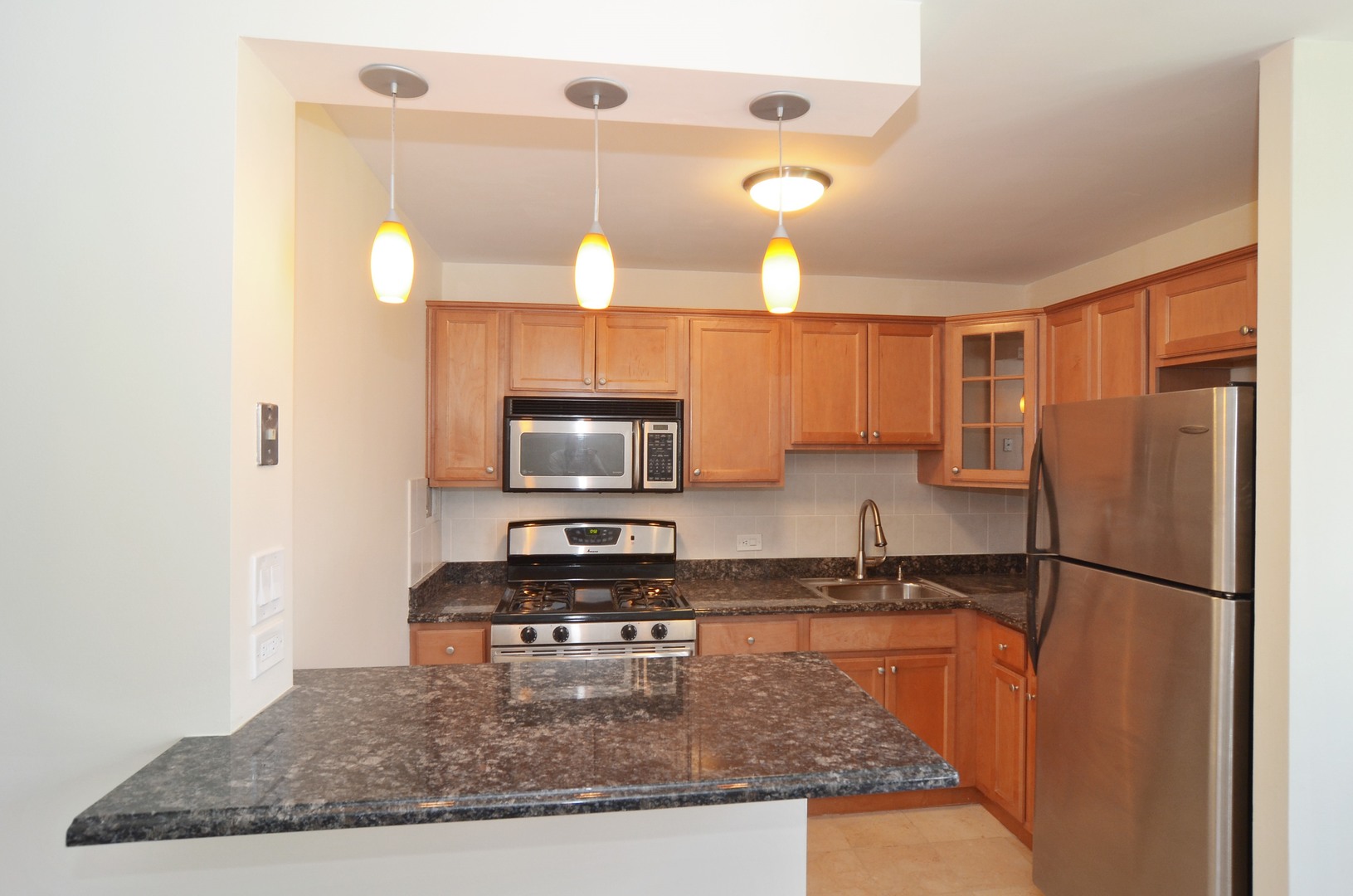 400 East Randolph Street, Unit 2222 Chicago, IL 60601 - Photo 5 of 18 a kitchen with a refrigerator a microwave a sink and cabinets