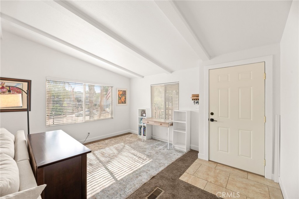 33653 Windmill Road Wildomar, CA 92595 - Photo 16 of 66 a spacious bedroom with a large bed a rug and a window