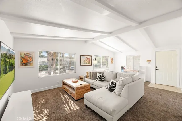 a large white kitchen with cabinets table and chairs