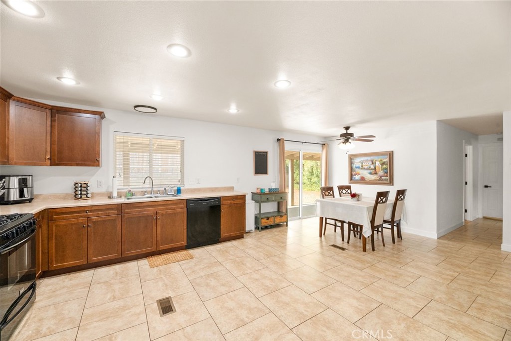 33653 Windmill Road Wildomar, CA 92595 - Photo 26 of 66 a large white kitchen with cabinets table and chairs