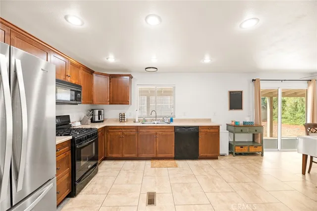 a large kitchen with a table and chairs