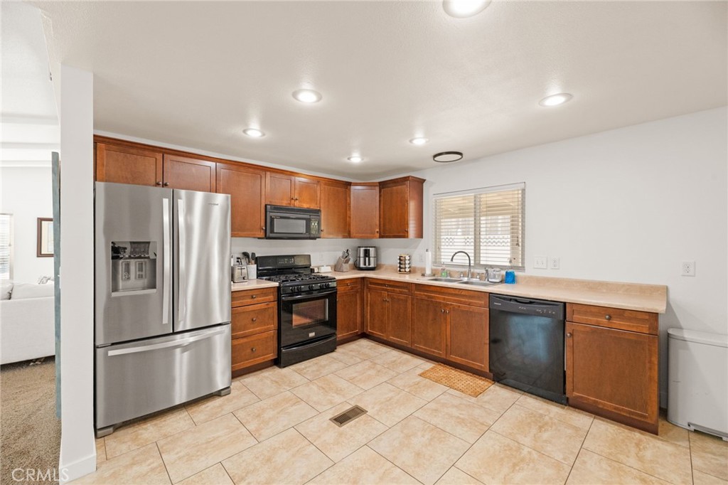 33653 Windmill Road Wildomar, CA 92595 - Photo 28 of 66 a kitchen with stainless steel appliances granite countertop a refrigerator sink and stove