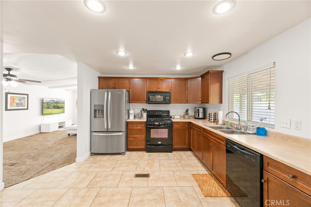 33653 Windmill Road Wildomar, CA 92595 - Photo 29 of 66 a large kitchen with stainless steel appliances kitchen island granite countertop a refrigerator and a sink
