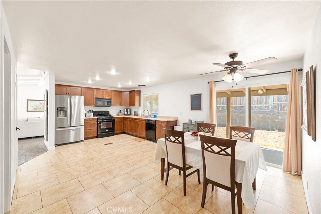 33653 Windmill Road Wildomar, CA 92595 - Photo 31 of 66 a view of kitchen and dining area with chandelier