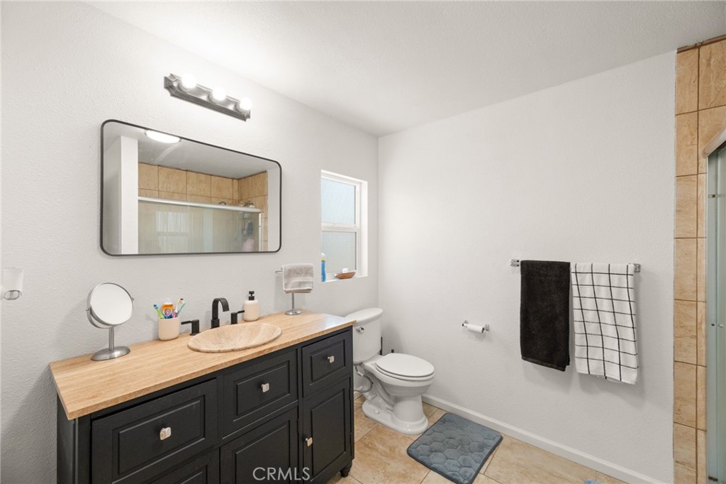 33653 Windmill Road Wildomar, CA 92595 - Photo 43 of 66 a bathroom with a toilet sink and mirror