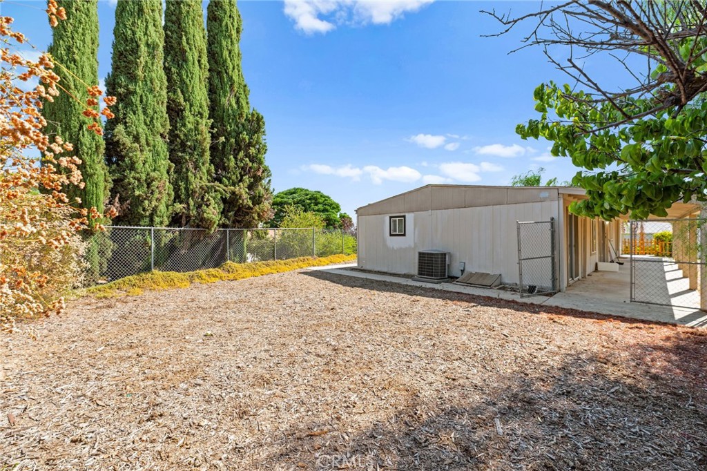 33653 Windmill Road Wildomar, CA 92595 - Photo 46 of 66 a backyard of a house with a yard and garage
