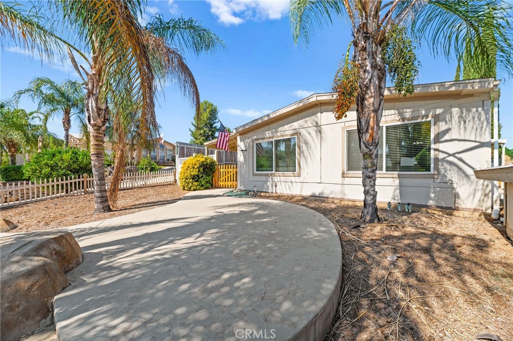 33653 Windmill Road Wildomar, CA 92595 - Photo 9 of 66 a view of a house with a yard and palm trees