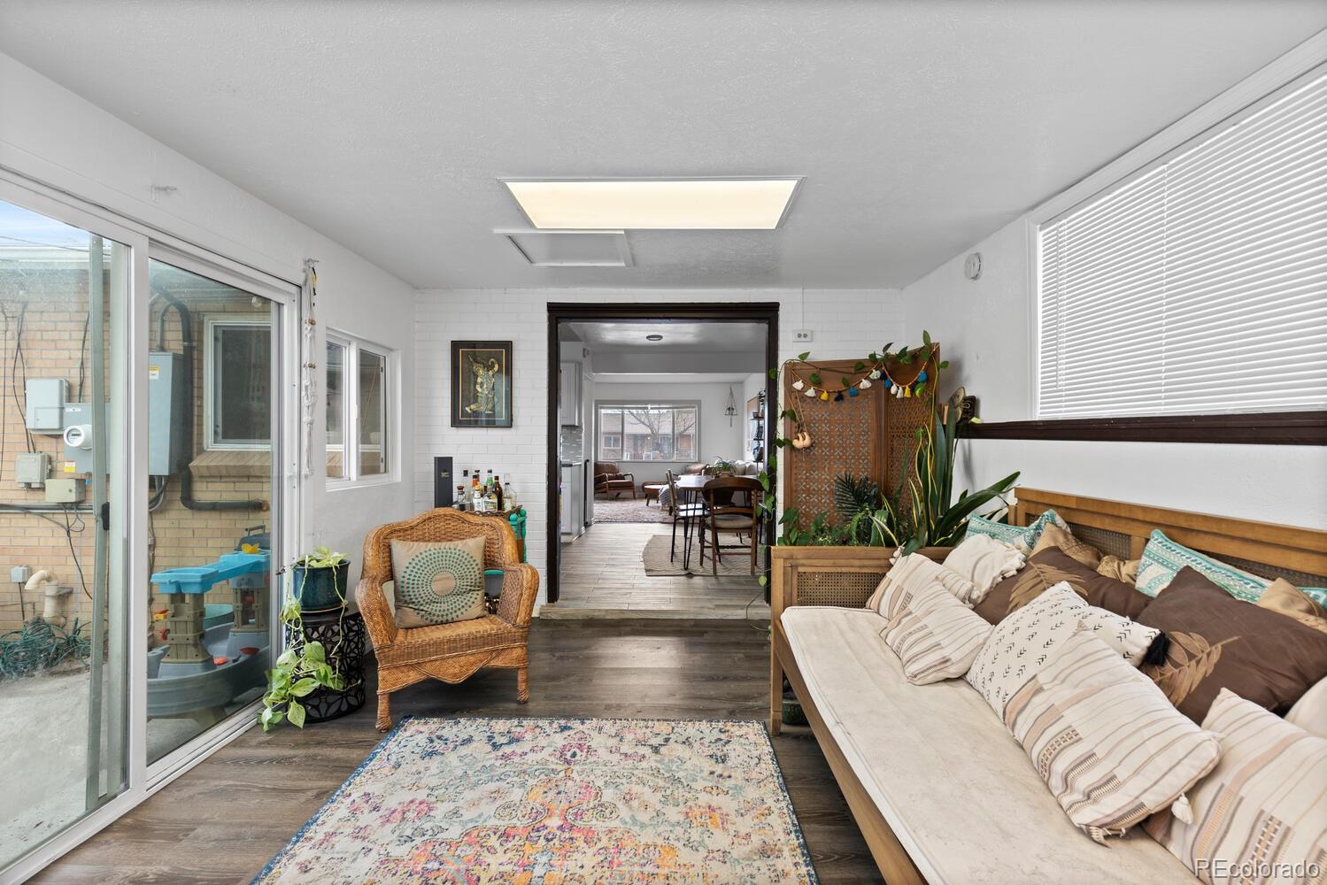 3106 South Wolff Street Denver, CO 80236 - Photo 12 of 48 a living room with furniture and a fireplace