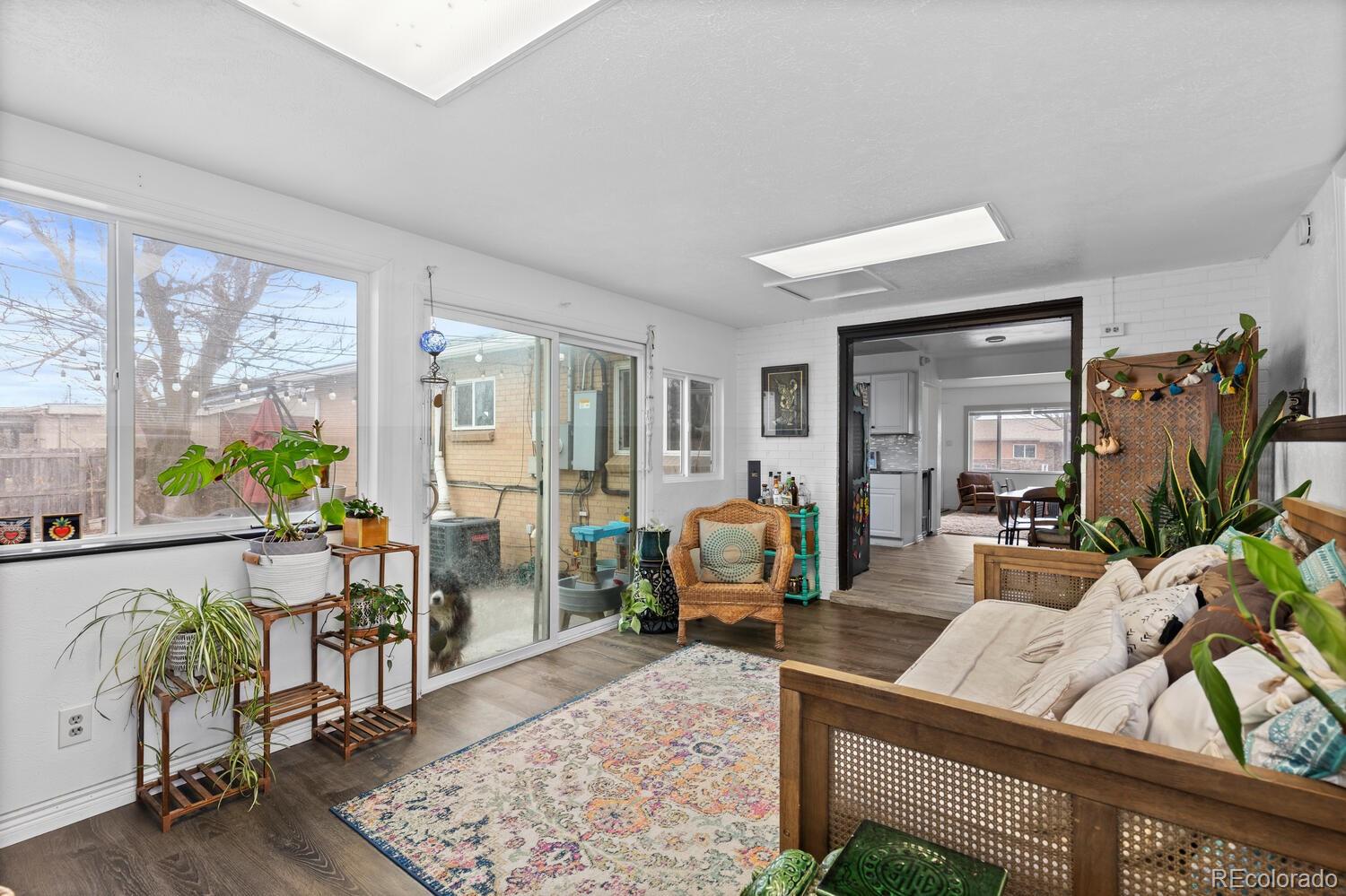 3106 South Wolff Street Denver, CO 80236 - Photo 13 of 48 a living room with furniture and a floor to ceiling window