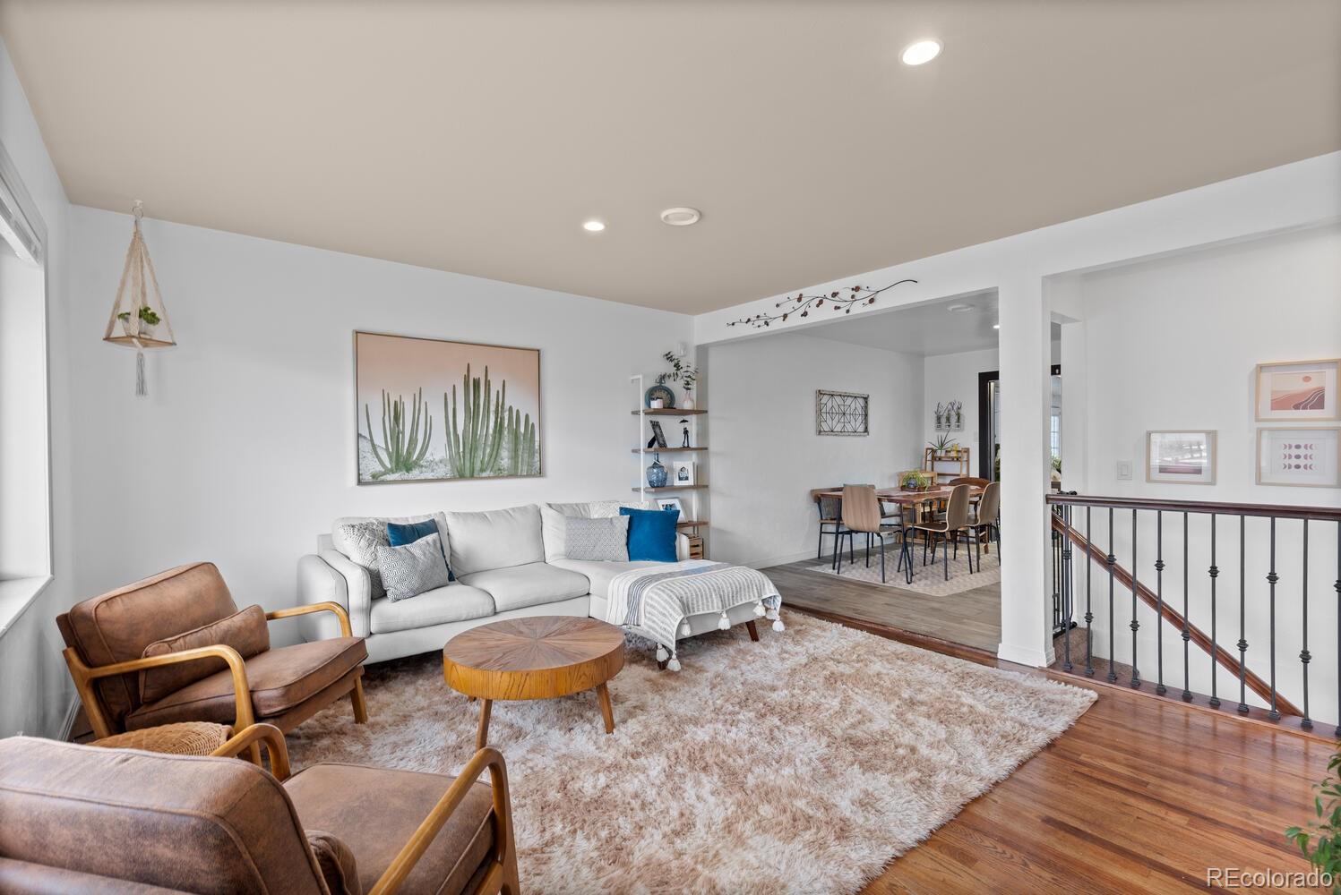 3106 South Wolff Street Denver, CO 80236 - Photo 14 of 48 a living room with furniture a rug and a chandelier