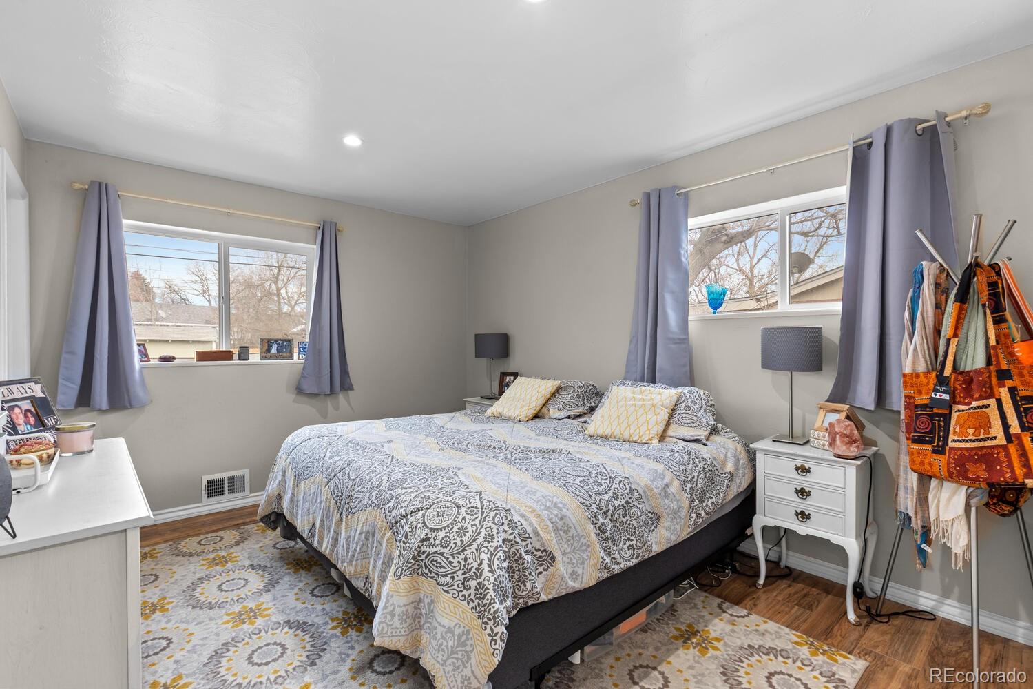 3106 South Wolff Street Denver, CO 80236 - Photo 16 of 48 a bedroom with a bed a dresser and a window