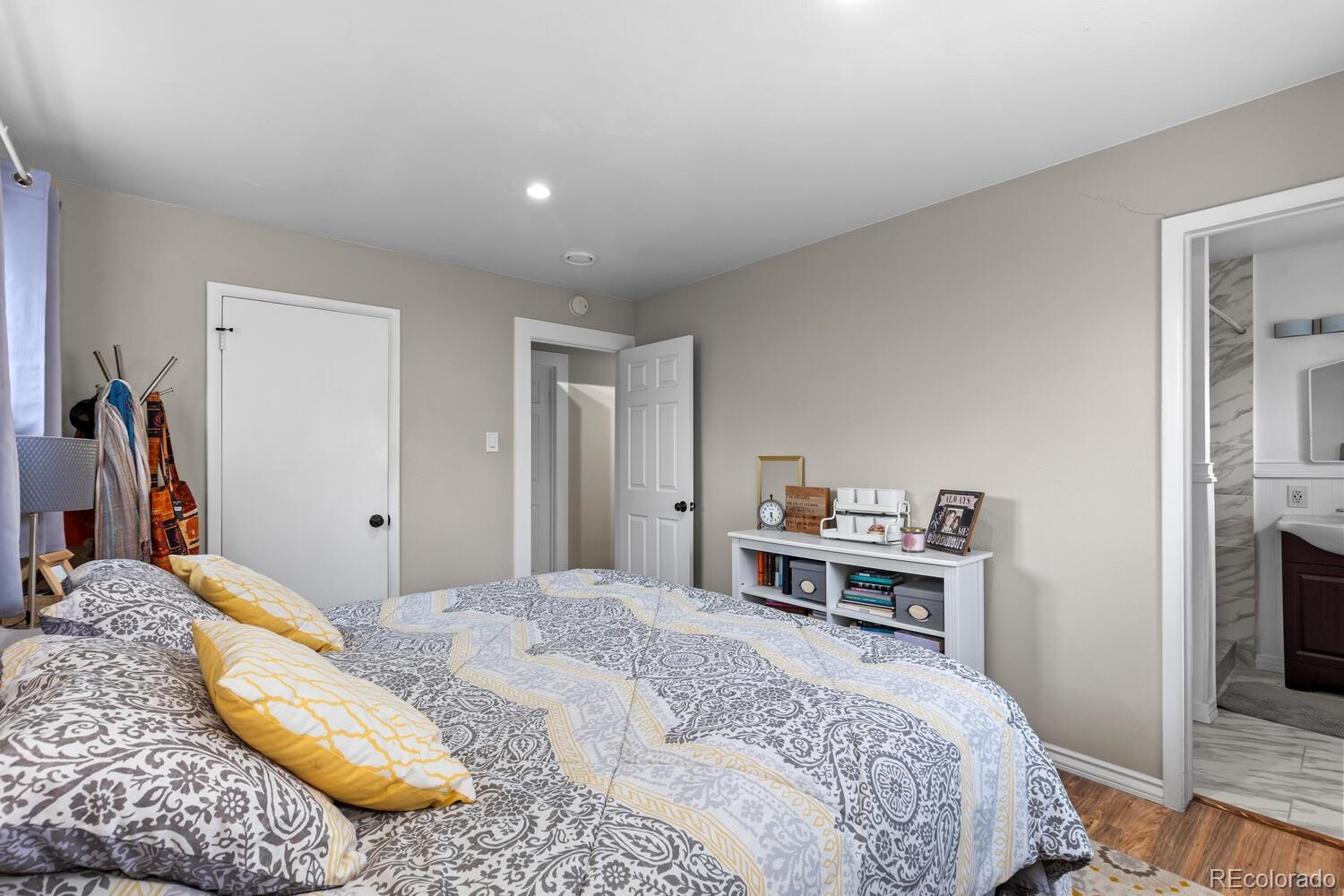 3106 South Wolff Street Denver, CO 80236 - Photo 17 of 48 a bedroom with a bed and a view of kitchen