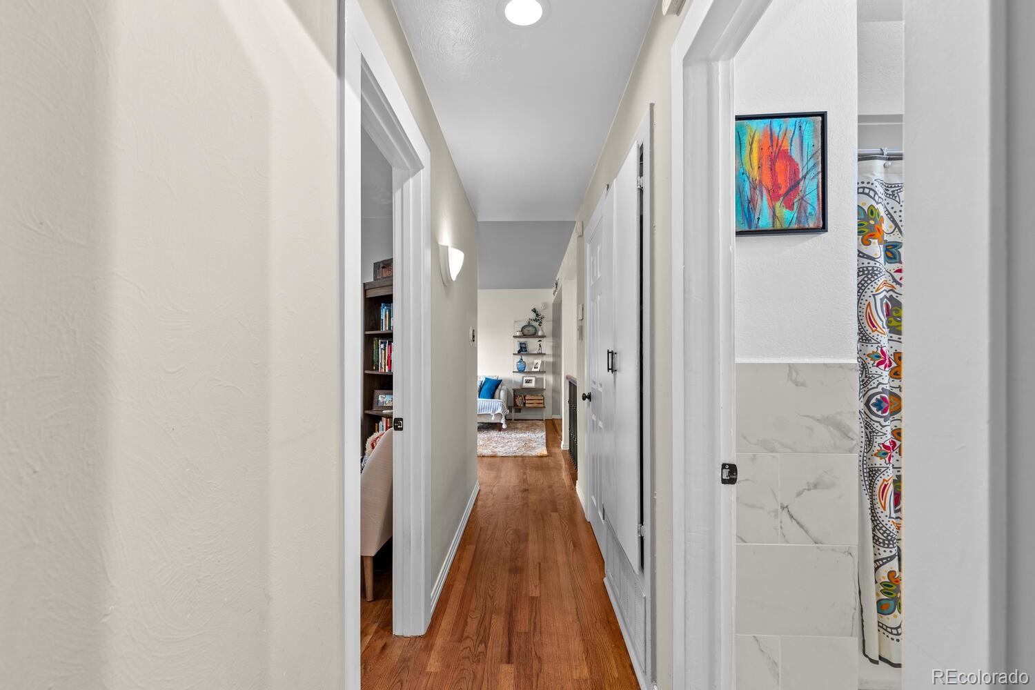 3106 South Wolff Street Denver, CO 80236 - Photo 20 of 48 a view of hallway with wooden floor and stairs