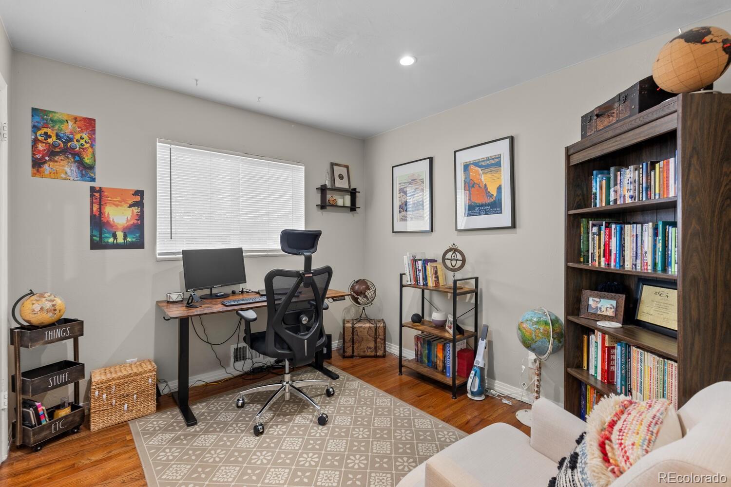 3106 South Wolff Street Denver, CO 80236 - Photo 22 of 48 a view of a workspace with a bookshelf