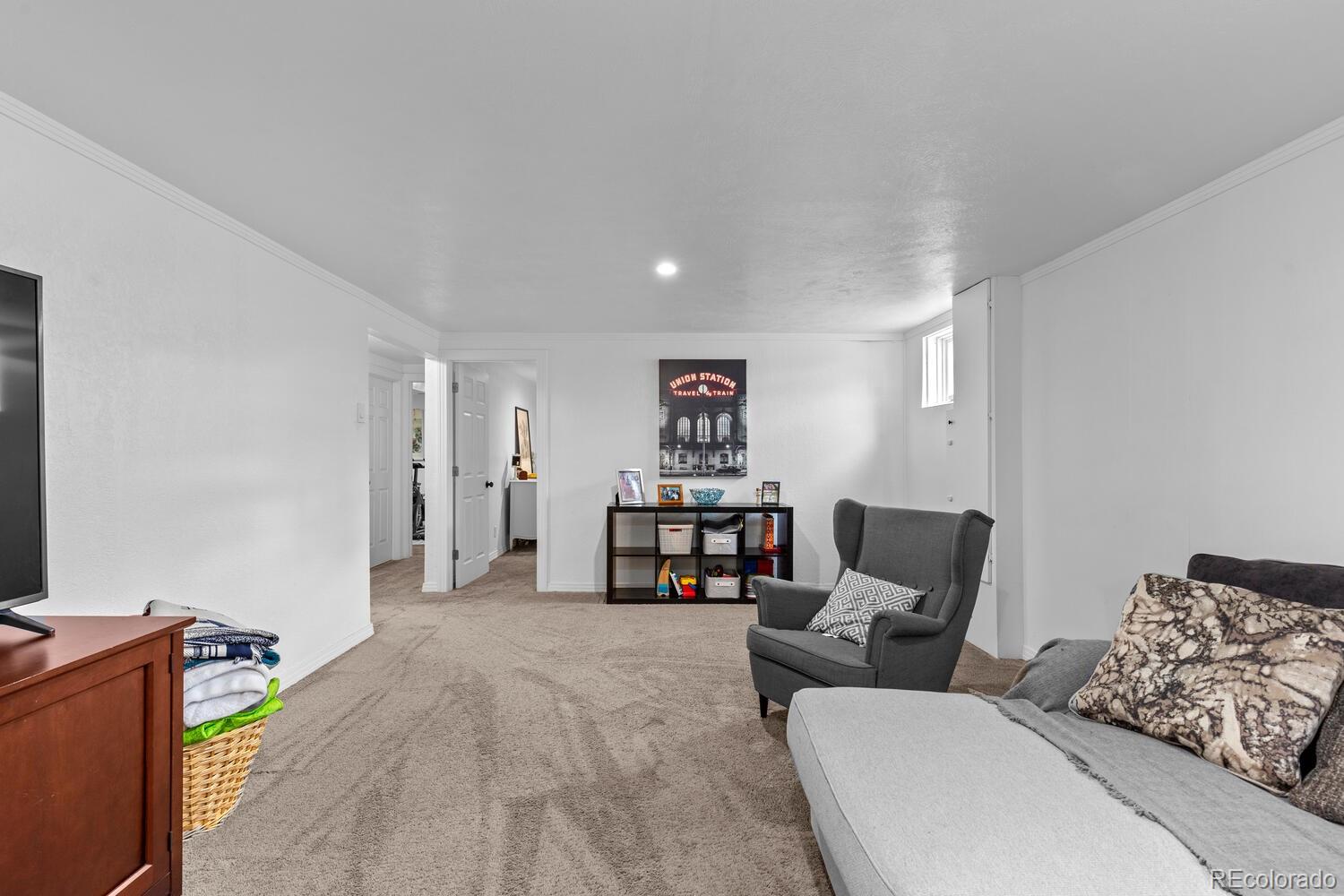 3106 South Wolff Street Denver, CO 80236 - Photo 24 of 48 a living room with furniture and a couch