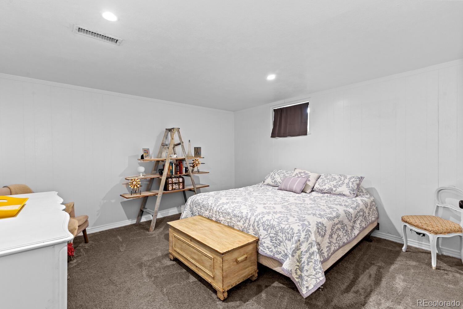 3106 South Wolff Street Denver, CO 80236 - Photo 29 of 48 a bedroom with a bed and a table in it