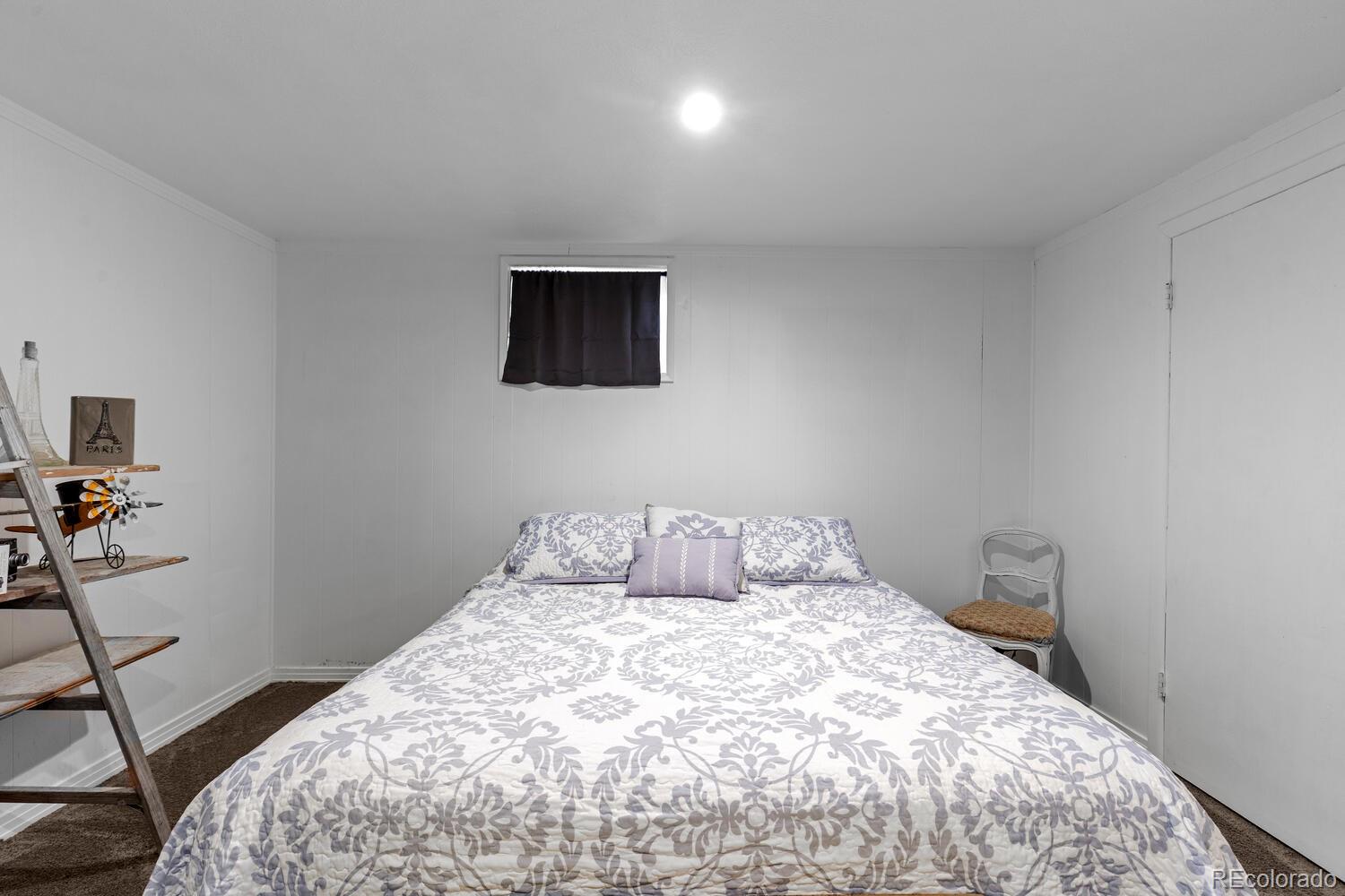 3106 South Wolff Street Denver, CO 80236 - Photo 31 of 48 a bedroom with a bed and a view of bathroom