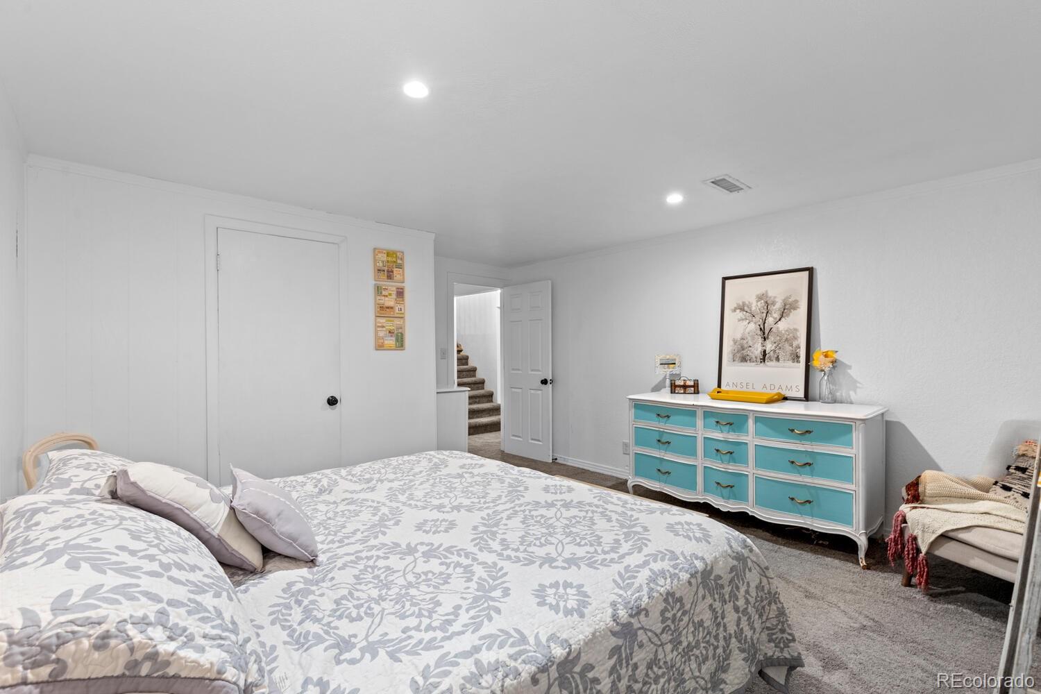 3106 South Wolff Street Denver, CO 80236 - Photo 32 of 48 a bedroom with a bed and a cabinets