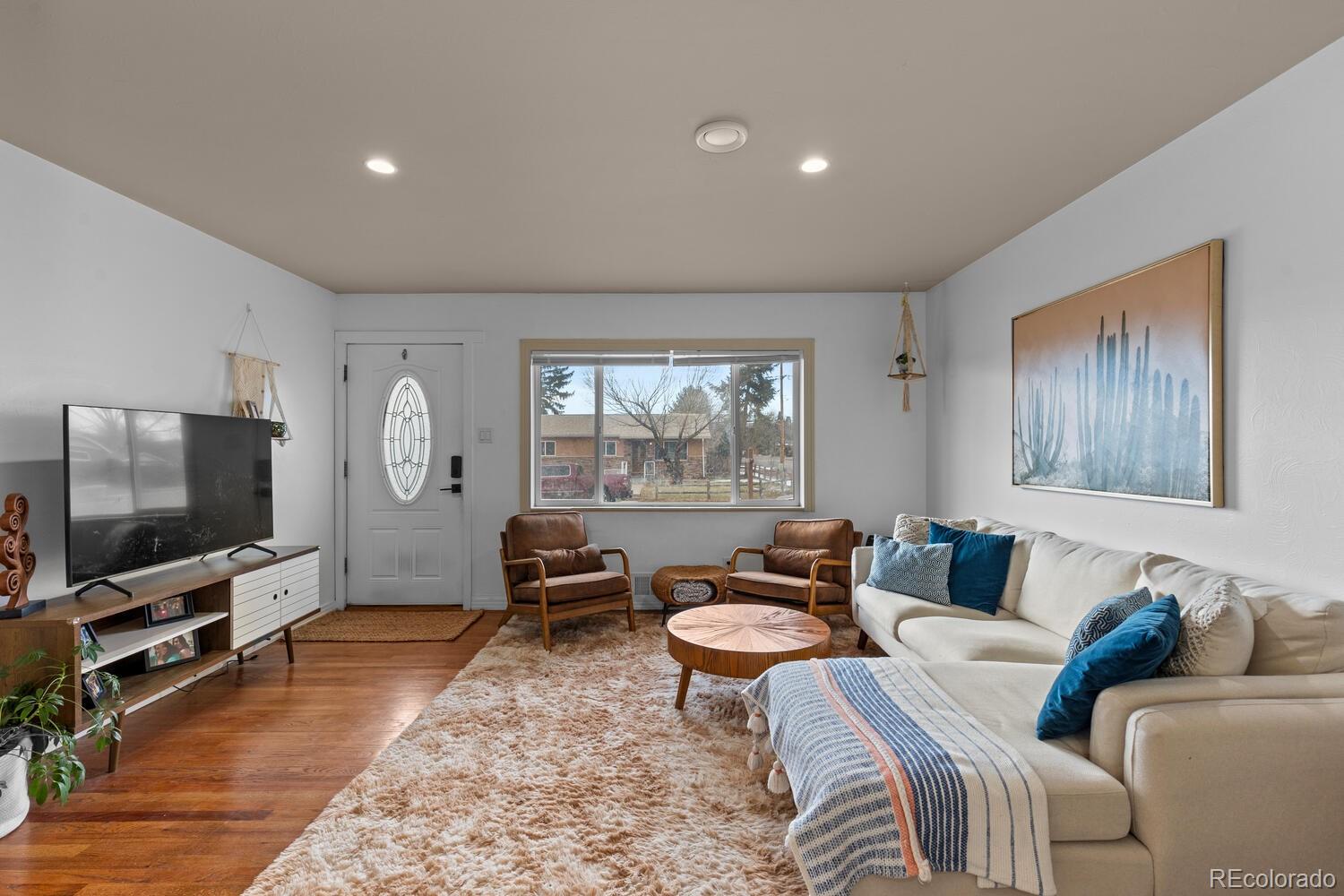 3106 South Wolff Street Denver, CO 80236 - Photo 33 of 48 a living room with furniture and a flat screen tv