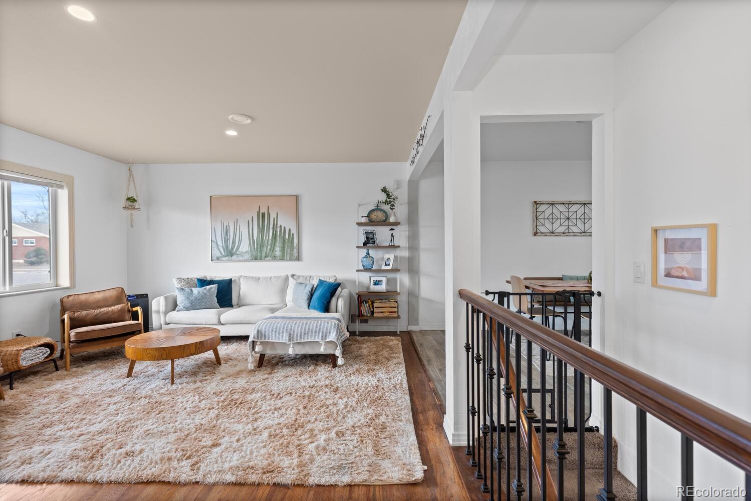 3106 South Wolff Street Denver, CO 80236 - Photo 34 of 48 a living room with furniture and a rug