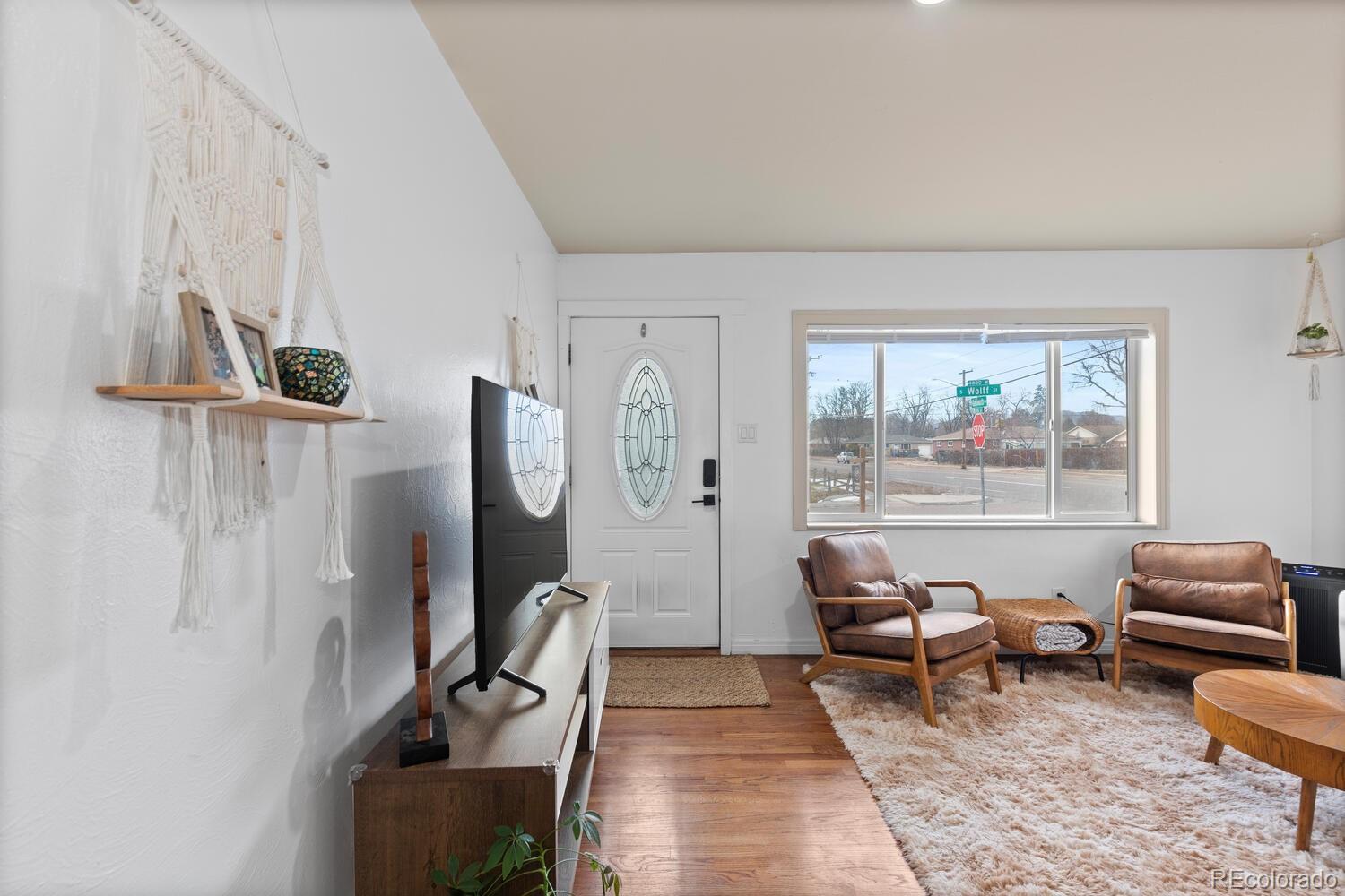 3106 South Wolff Street Denver, CO 80236 - Photo 35 of 48 a living room with furniture and a window