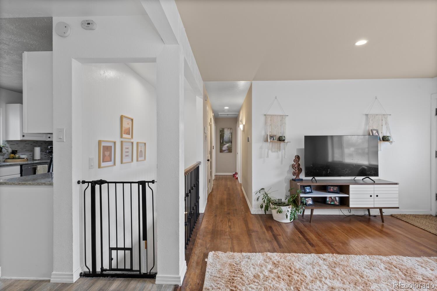 3106 South Wolff Street Denver, CO 80236 - Photo 36 of 48 a living room with furniture and a flat screen tv