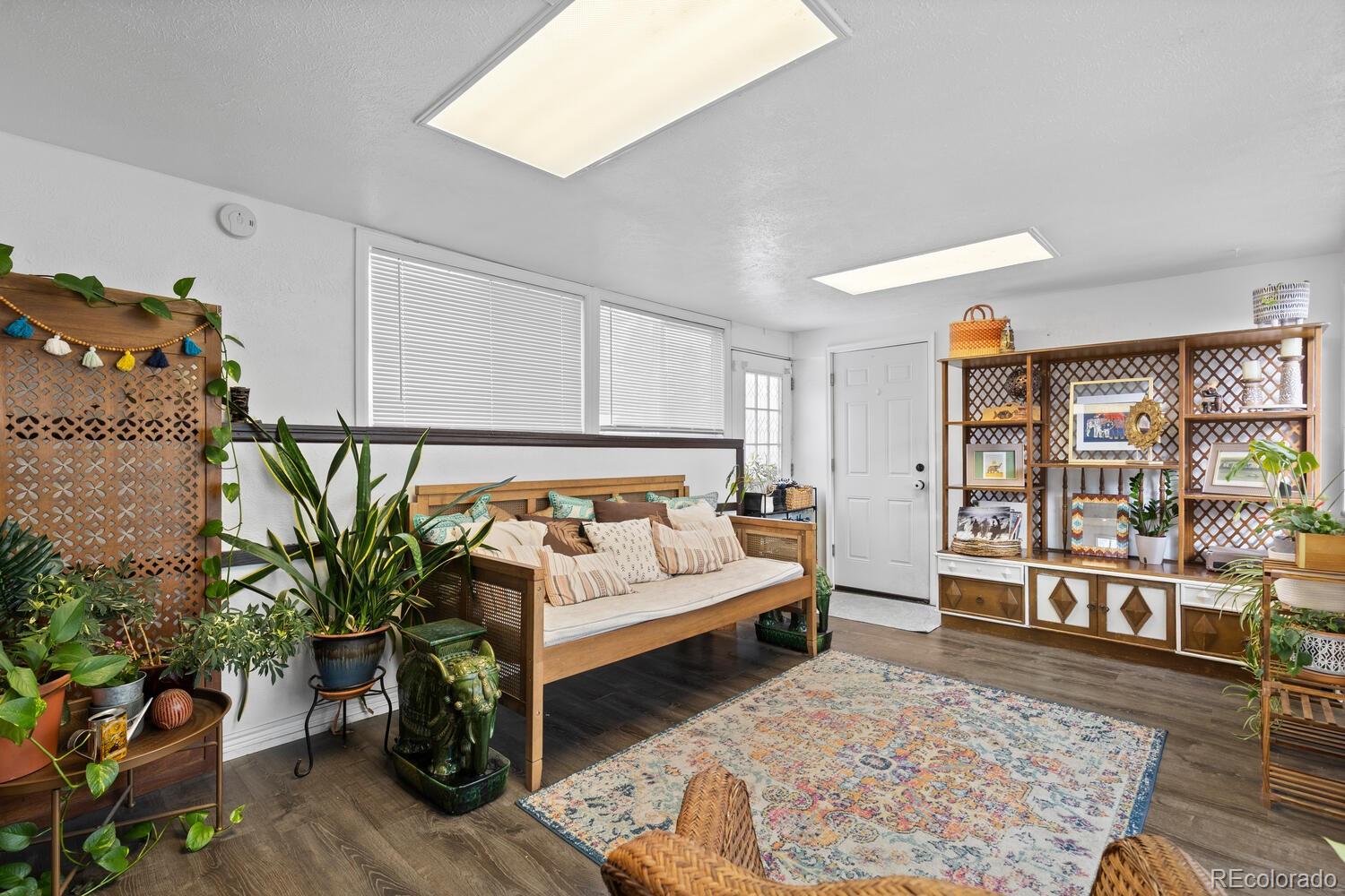 3106 South Wolff Street Denver, CO 80236 - Photo 39 of 48 a bedroom with furniture window and wooden floor