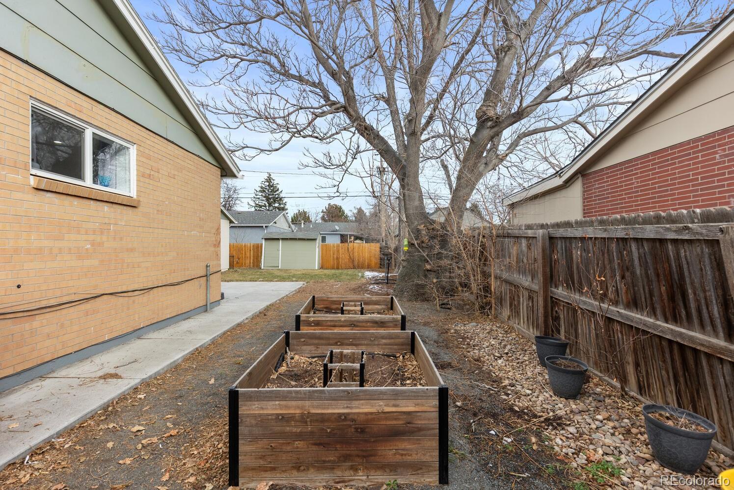 3106 South Wolff Street Denver, CO 80236 - Photo 40 of 48 a view of a deck with wooden floor and a fence