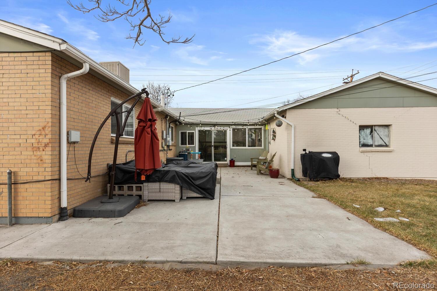 3106 South Wolff Street Denver, CO 80236 - Photo 41 of 48 a view of a house with a patio