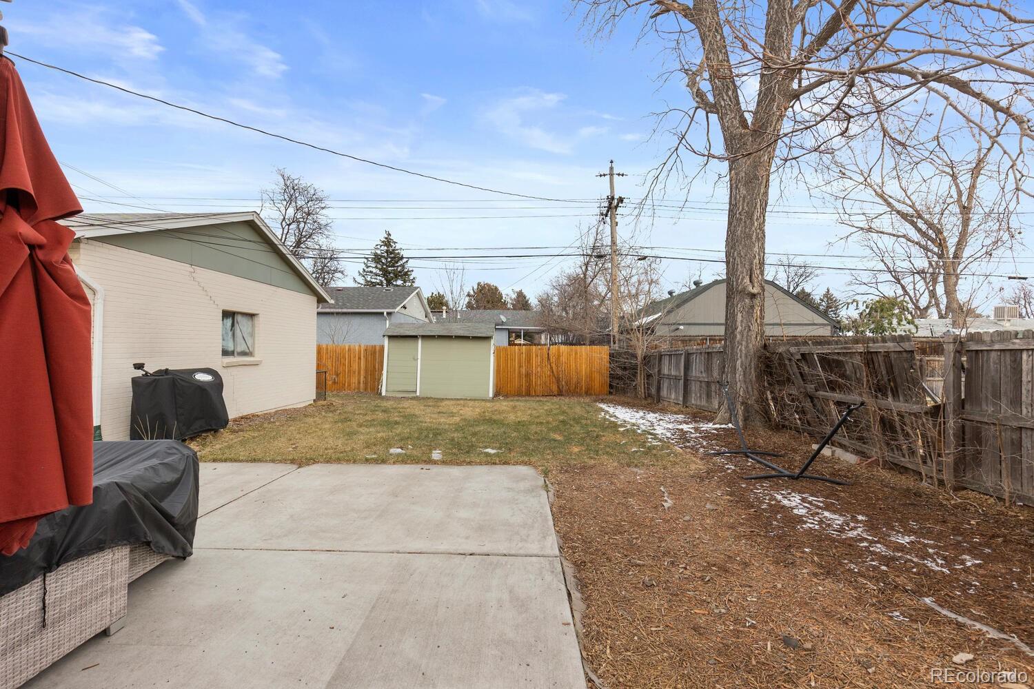 3106 South Wolff Street Denver, CO 80236 - Photo 42 of 48 a view of a house with a patio