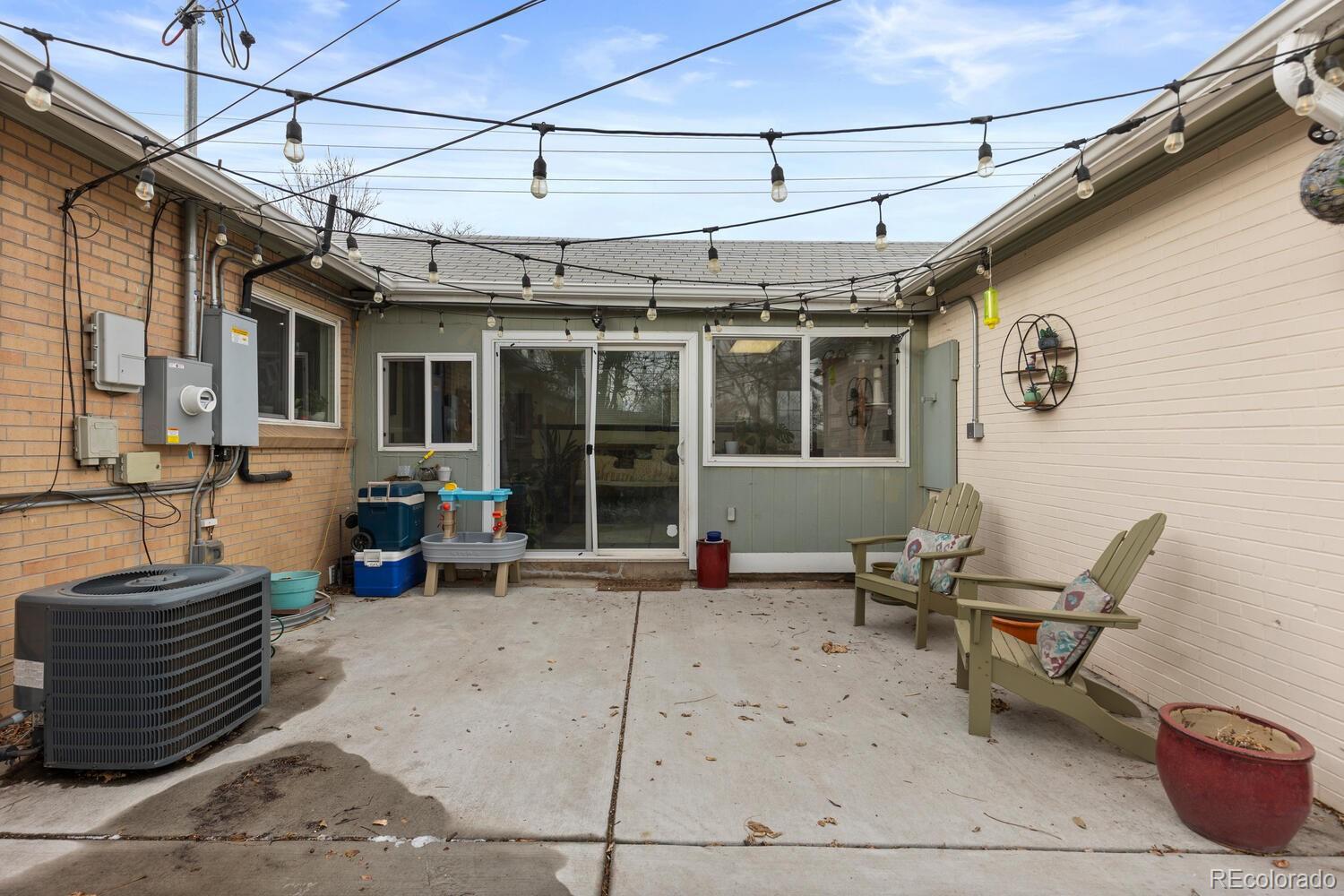 3106 South Wolff Street Denver, CO 80236 - Photo 45 of 48 a view of a chairs and table in a patio