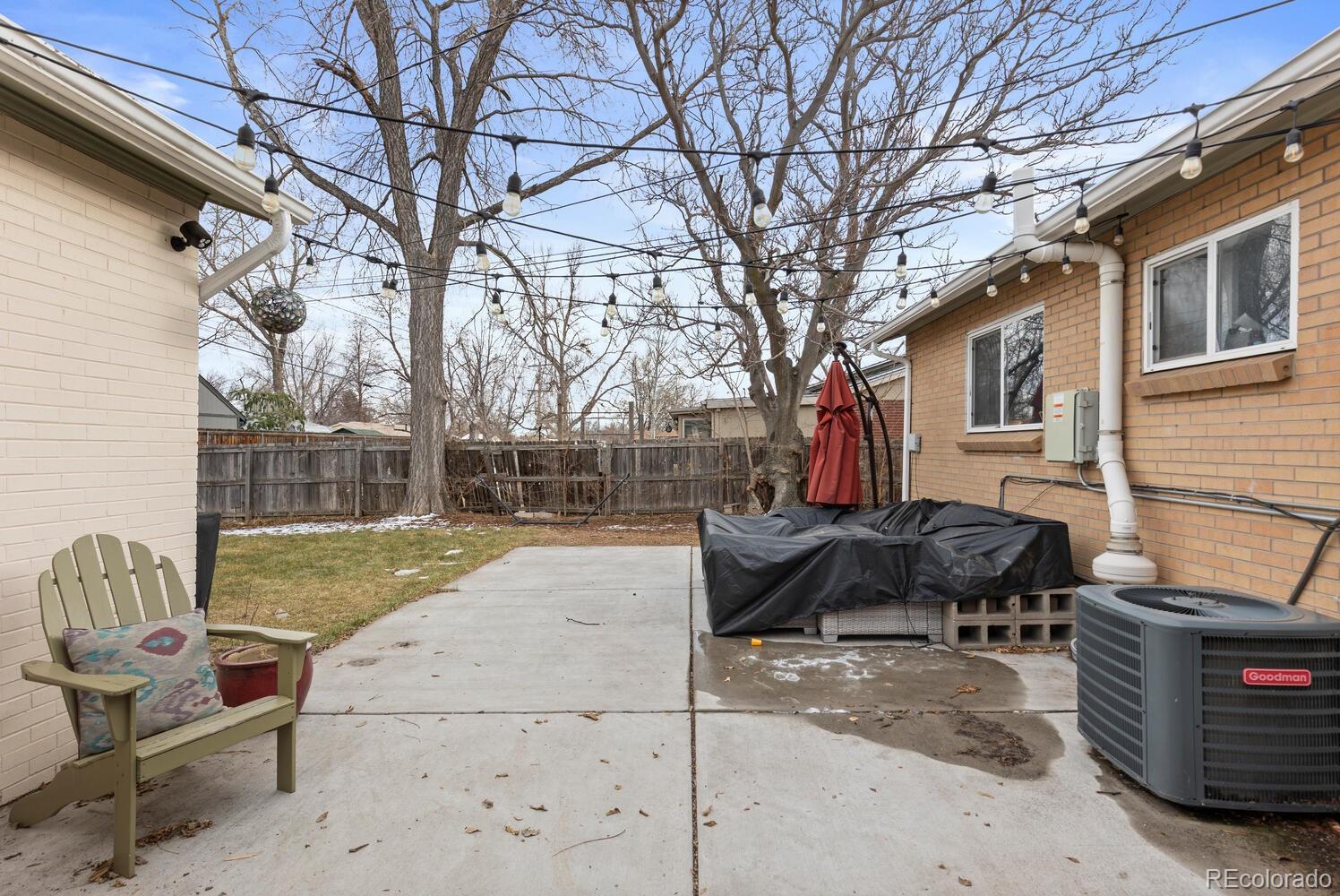 3106 South Wolff Street Denver, CO 80236 - Photo 46 of 48 a backyard of a house with barbeque oven and outdoor seating