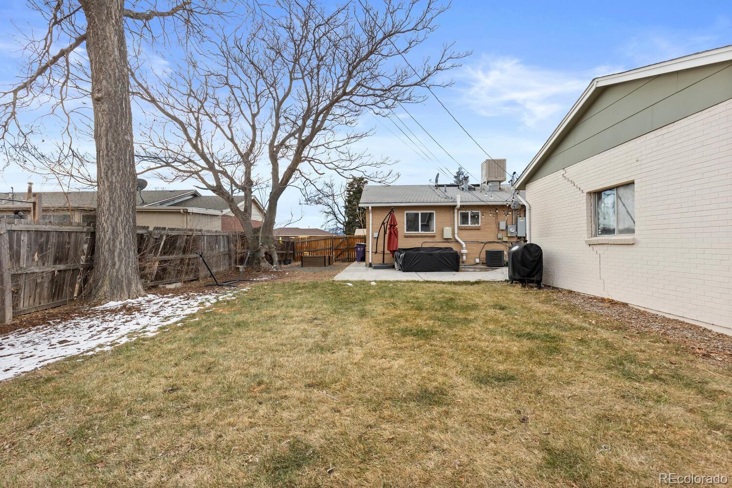 3106 South Wolff Street Denver, CO 80236 - Photo 47 of 48 a front view of a house with a yard